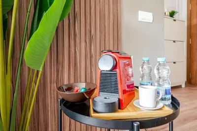 a table with a toaster and water bottles on it at Cozy studio 5 min Casa port Parking Netflix in Casablanca