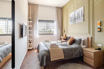 a bedroom with a bed and a couch in it at Cozy studio 5 min Casa port Parking Netflix in Casablanca