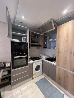 a kitchen with a stove and a washer and dryer at Appartement fraichement rénové à Agdal in Rabat