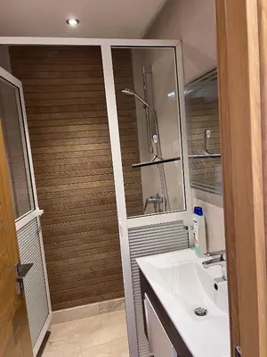 a bathroom with a sink and a shower and a mirror at Appartement fraichement rénové à Agdal in Rabat