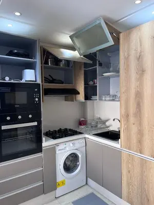 a kitchen with a washing machine and a washer at Appartement fraichement rénové à Agdal in Rabat