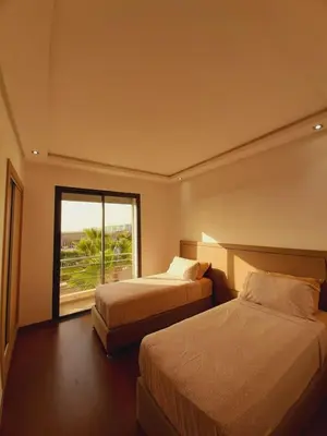 a hotel room with two beds and a window at Mansouria Beach Resort in Mohammedia