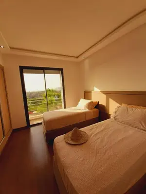 a hotel room with two beds and a window at Mansouria Beach Resort in Mohammedia