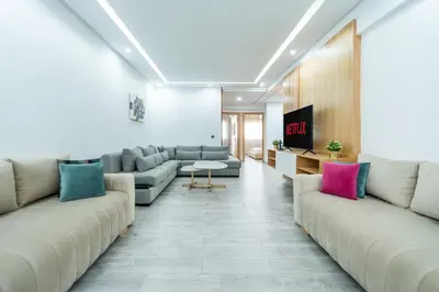 a living room with couches and a tv at Luxury cozy apartment in Casablanca