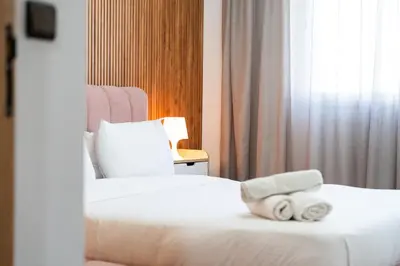 two beds in a hotel room with towels on them at Luxury cozy apartment in Casablanca