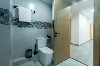 a bathroom with a toilet and a glass shower at Luxury cozy apartment in Casablanca