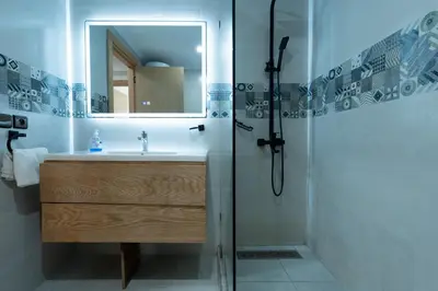 a bathroom with a sink and a shower with a mirror at Luxury cozy apartment in Casablanca