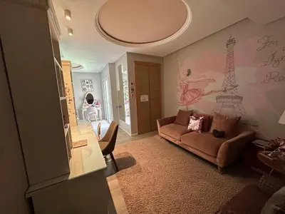 a living room with a couch and the eiffel tower mural at 1700sqm Unique Villa in Bouskoura in Bouskoura