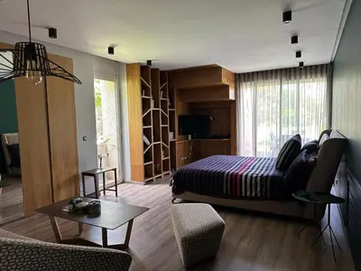 a bedroom with a bed and a living room at 1700sqm Unique Villa in Bouskoura in Bouskoura