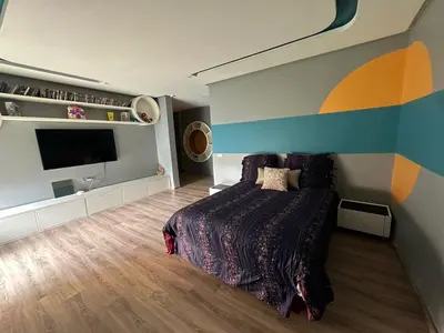 a bedroom with a bed and a flat screen tv at 1700sqm Unique Villa in Bouskoura in Bouskoura