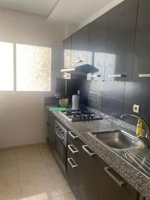 a kitchen with a sink and a stove at Apartment Casa Marina - Borgone, Ocean & Hassan II Views in Casablanca