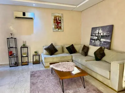 a living room with a couch and a coffee table at Apartment Casa Marina - Borgone, Ocean & Hassan II Views in Casablanca