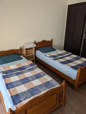 two beds sitting next to each other in a room at appartement cité marine plage 5min in O Ben Slimane
