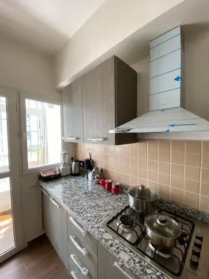 a kitchen with two pots on a stove top at appartement cité marine plage 5min in O Ben Slimane