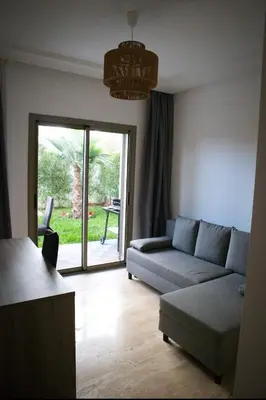a living room with a couch and a table at KST Home-Heaven Beach Sidi Rahal in Sidi Rahal