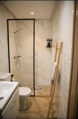 a bathroom with a shower with a toilet and a sink at KST Home-Heaven Beach Sidi Rahal in Sidi Rahal
