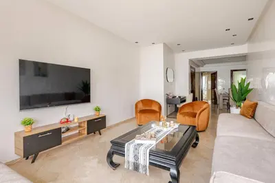 a living room with a couch and a table at Luxury Garden View Apartment Private Floor in Casablanca