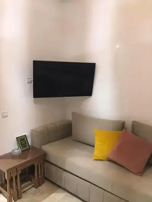 a living room with a couch and a flat screen tv at Salam Beach in Pont Blondin