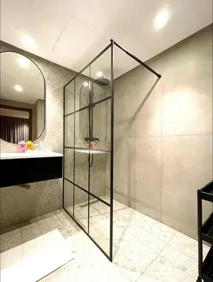 a glass shower in a bathroom with a sink at A102 Studio cosy & chic in Casablanca