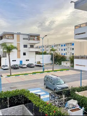 a car parked in a parking lot in front of a building at Marbella beach in Mansouria