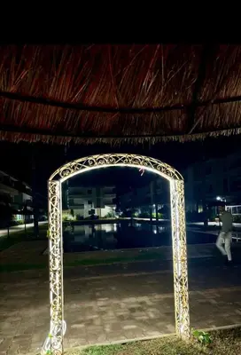 a metal arch in front of a building at night at Marbella beach in Mansouria