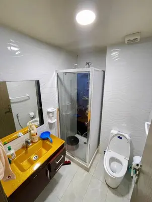 a bathroom with a yellow sink and a toilet at Marbella beach in Mansouria