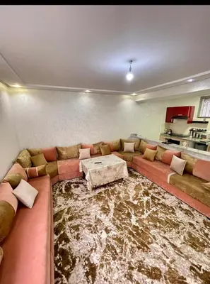 a living room with a couch and a table at Marbella beach in Mansouria