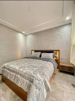 a bedroom with a large bed in a room at Marbella beach in Mansouria