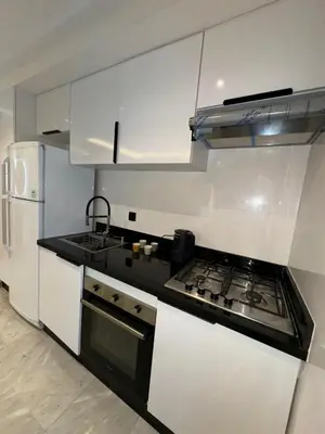 a kitchen with a stove and a white refrigerator at Stay Bright with Hometa in Casablanca