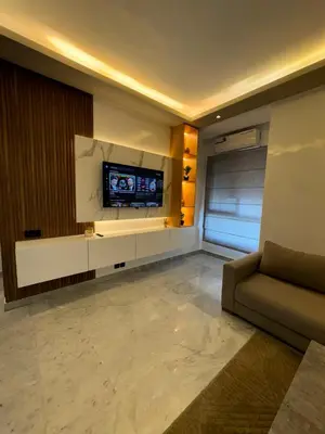 a living room with a couch and a tv on a wall at Stay Bright with Hometa in Casablanca