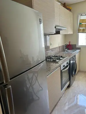 a kitchen with a stainless steel refrigerator and a dishwasher at Kettani Shems Bouznika in Bouznika