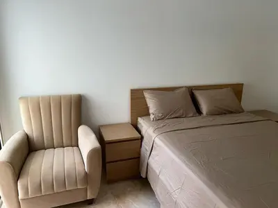 a bedroom with a bed and a chair at Kettani Shems Bouznika in Bouznika