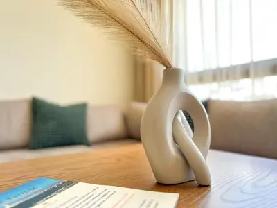 a white vase sitting on a table with a fan at Small Cozy Nest in Quiet Area - Central with Balcony in Casablanca
