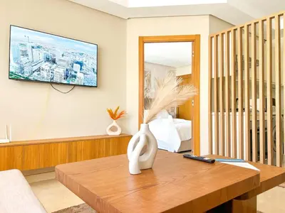 a living room with a vase on a wooden table at Small Cozy Nest in Quiet Area - Central with Balcony in Casablanca