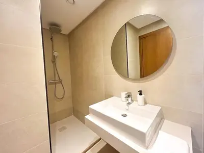 a bathroom with a white sink and a mirror at Small Cozy Nest in Quiet Area - Central with Balcony in Casablanca