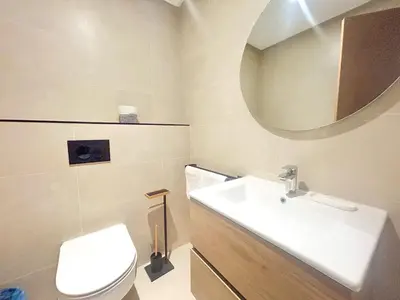 a bathroom with a sink and a toilet and a mirror at Small Cozy Nest in Quiet Area - Central with Balcony in Casablanca