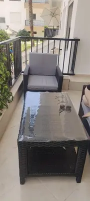 a patio with a table and a couch on a balcony at yakout in Mohammedia