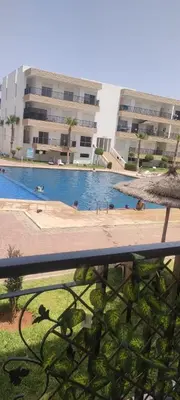 a swimming pool in front of a building at yakout in Mohammedia