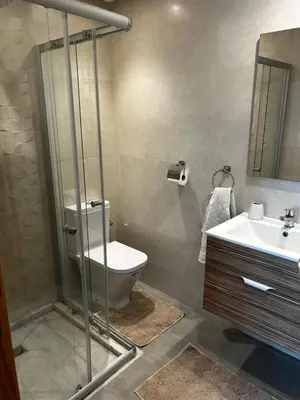 a bathroom with a toilet and a sink at Sidi Rahal Blue Beach in El Jadida