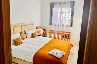 a bedroom with a large bed with towels on it at A 2min hôpital M6,Proche d'Aéroport et la gare bouskoura in Bouskoura