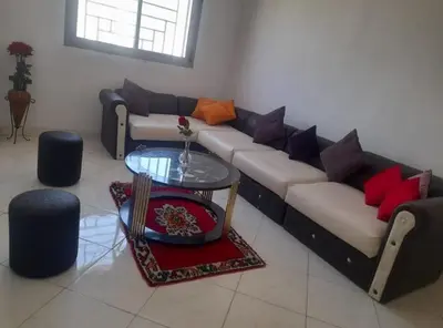 a living room with a couch and a table at A 2min hôpital M6,Proche d'Aéroport et la gare bouskoura in Bouskoura