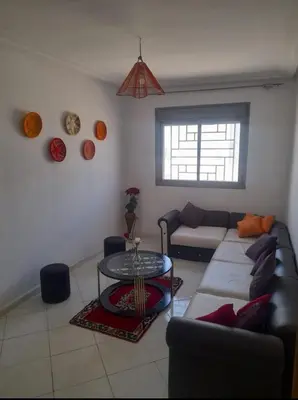 a living room with a couch and a table at A 2min hôpital M6,Proche d'Aéroport et la gare bouskoura in Bouskoura
