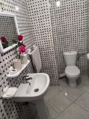 a bathroom with a white sink and a toilet at A 2min hôpital M6,Proche d'Aéroport et la gare bouskoura in Bouskoura