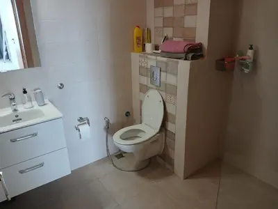 a bathroom with a toilet and a sink at Vakantie app charmante Harhoura in Temara