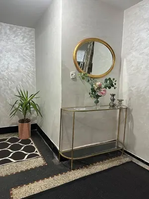 a room with a mirror and a glass shelf with flowers at Cosy 2BR in Heart of Casablanca in Casablanca