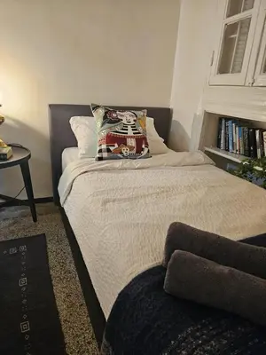 a bed with a pillow on it in a bedroom at Cosy 2BR in Heart of Casablanca in Casablanca