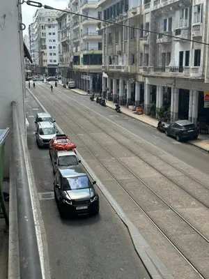 a group of cars parked on the side of a street at Cosy 2BR in Heart of Casablanca in Casablanca