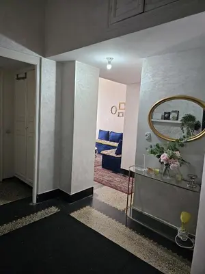 a hallway with a mirror and a table with flowers at Cosy 2BR in Heart of Casablanca in Casablanca
