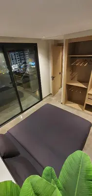 a living room with a table and a large window at Maârif Penthouse in Casablanca