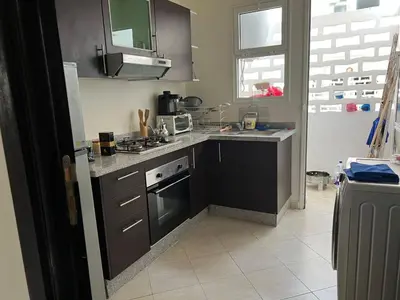 a kitchen with a sink and a stove top oven at Beautiful 2 bedrooms apartment in Bouznika in Bouznika